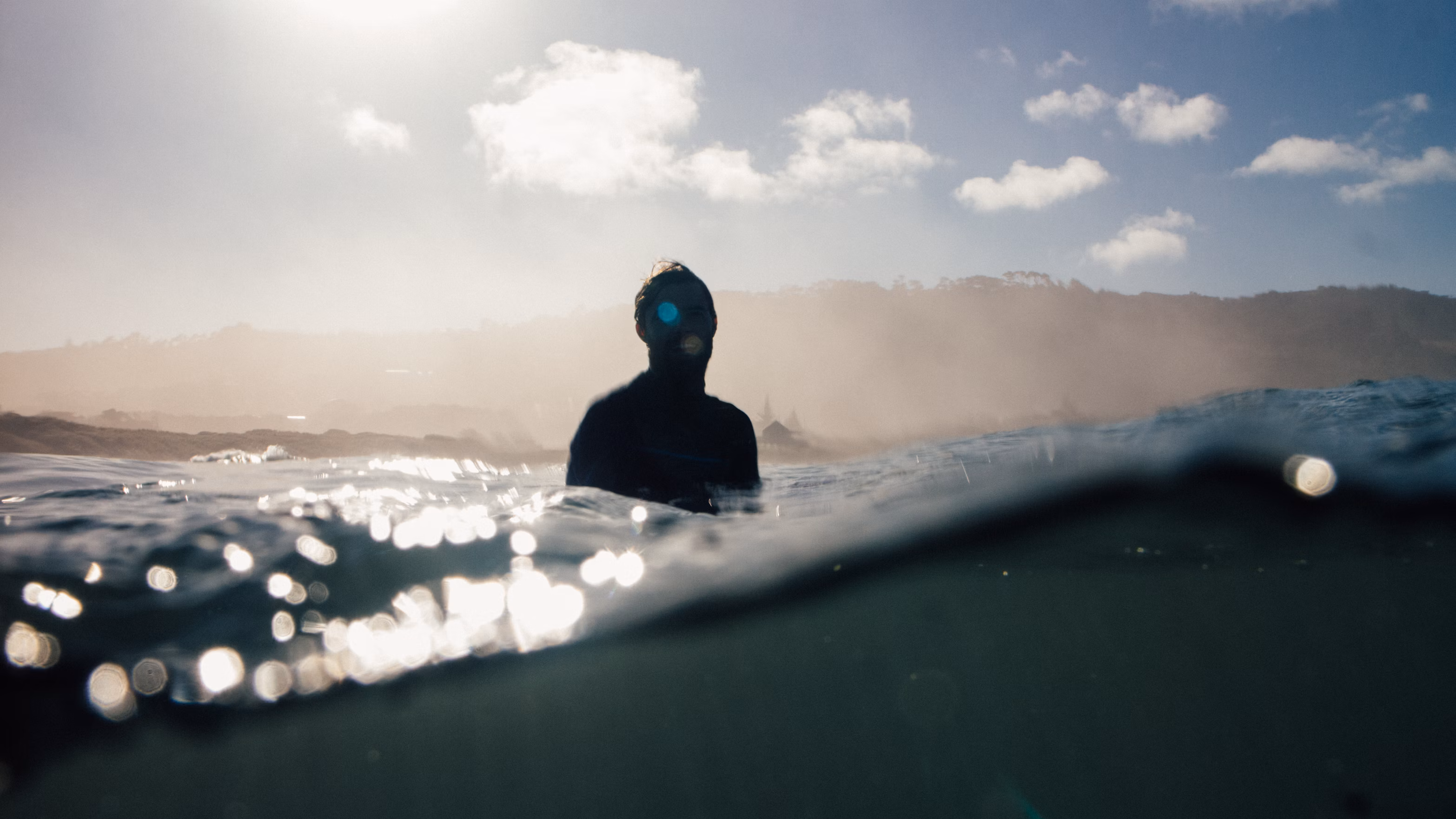 Surfer in the water at Muriwai